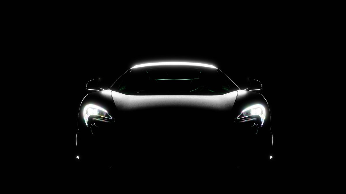 Silhouette of black sports car with headlights on black background